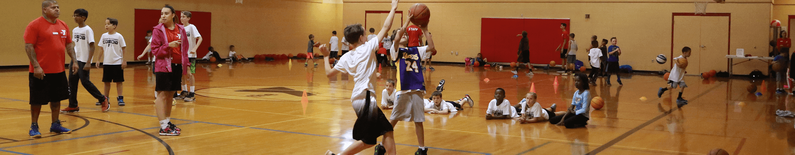 Group of children playing basketball in a gym